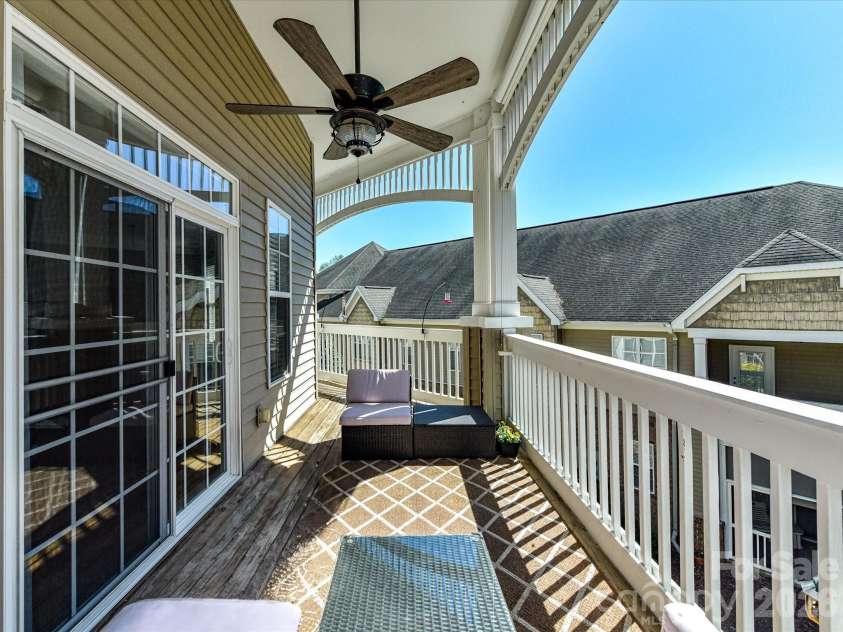 8665 Edinburgh Square Drive, Cornelius, NC 28031.  MLS# CAR4357240, YatesRealty ID 15038. Covered, Expansive porch featuring a ceiling fan and private, elevated views—perfect for relaxing or entertaining outdoors.