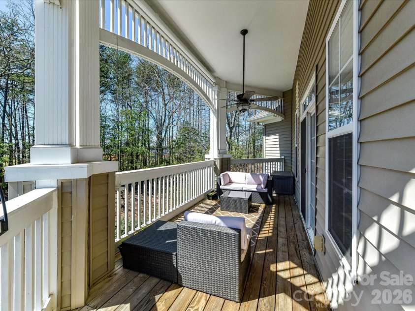8665 Edinburgh Square Drive, Cornelius, NC 28031.  MLS# CAR4357240, YatesRealty ID 15038. Covered, Expansive porch featuring a ceiling fan and private, elevated views—perfect for relaxing or entertaining outdoors.