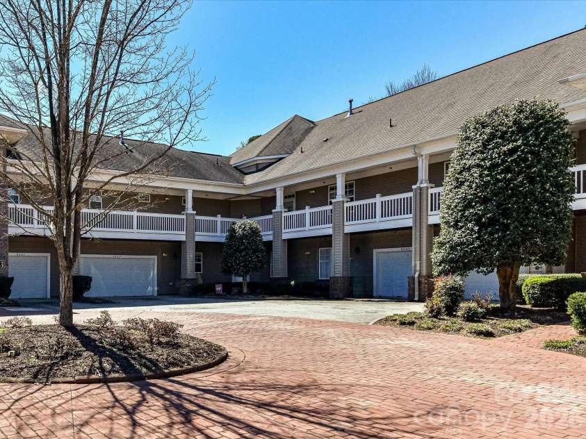 8665 Edinburgh Square Drive, Cornelius, NC 28031.  MLS# CAR4357240, YatesRealty ID 15038. Well-maintained condo community featuring a private courtyard with brick paver drive, mature landscaping, and convenient attached garage access.