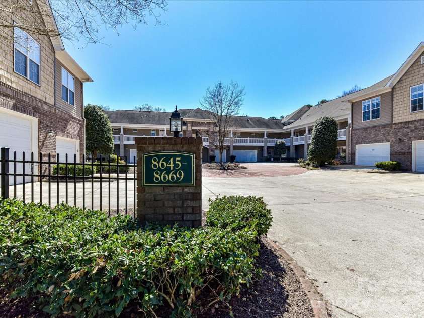 8665 Edinburgh Square Drive, Cornelius, NC 28031.  MLS# CAR4357240, YatesRealty ID 15038. Well-maintained condo community featuring a private courtyard with brick paver drive, mature landscaping, and convenient attached garage access.