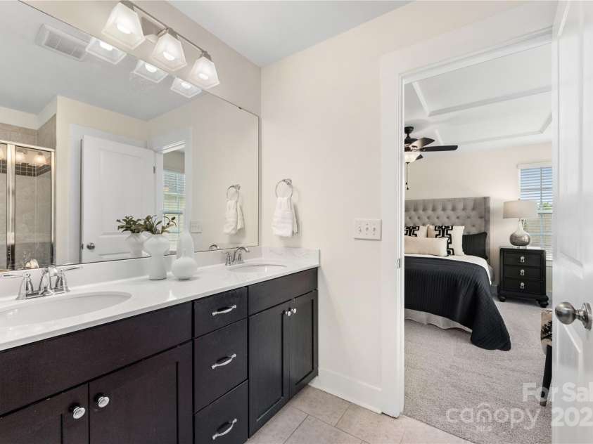 2638 Double Oaks Road, Charlotte, NC 28206.  MLS# CAR4252717, YatesRealty ID 15041. Primary bathroom features vanity with dual sinks and an over-sized walk-in shower with bench.