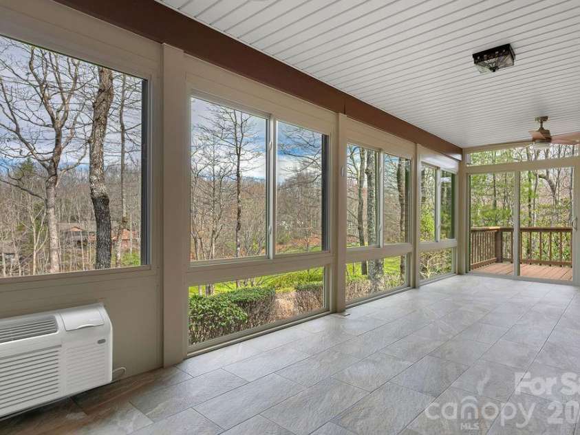 400 Middle Connestee Trail, Brevard, NC 28712.  MLS# CAR4354726, YatesRealty ID 15049. Sun porch