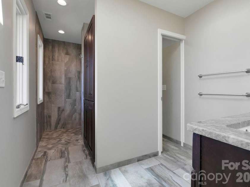 400 Middle Connestee Trail, Brevard, NC 28712.  MLS# CAR4354726, YatesRealty ID 15049. Upper main bath