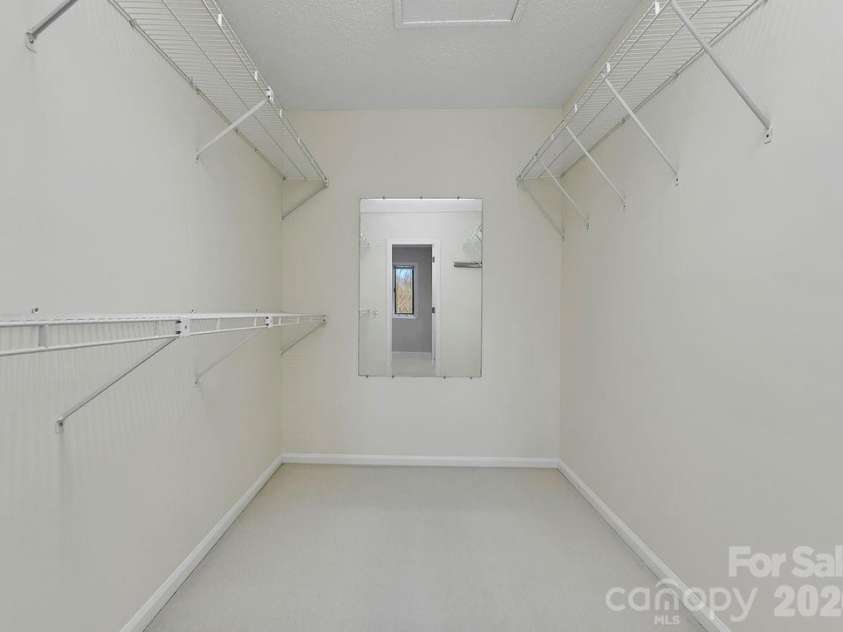 400 Middle Connestee Trail, Brevard, NC 28712.  MLS# CAR4354726, YatesRealty ID 15049. Upper main bedroom walk-in closet