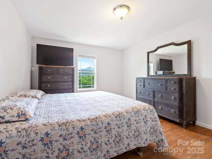 618 Enka Lake Road, Candler, NC 28715.  MLS# CAR4260345, YatesRealty ID 15064. Ensuite Primary bedroom with views
