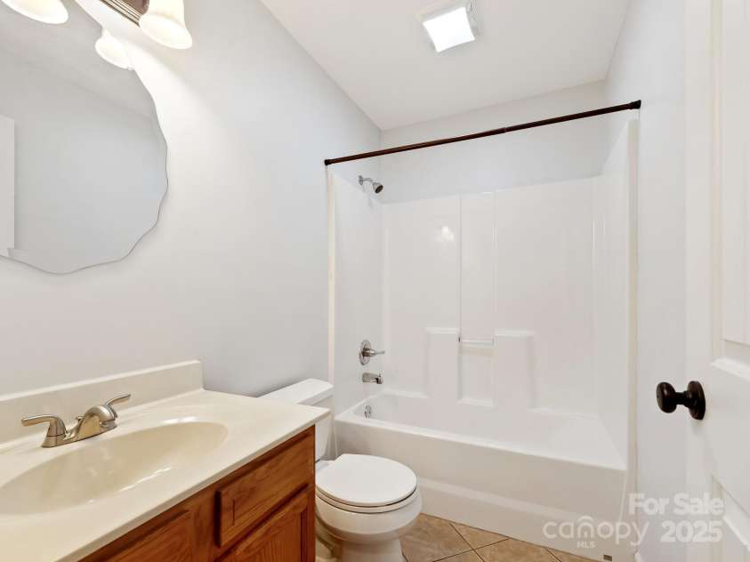 618 Enka Lake Road, Candler, NC 28715.  MLS# CAR4260345, YatesRealty ID 15064. Hall Bathroom