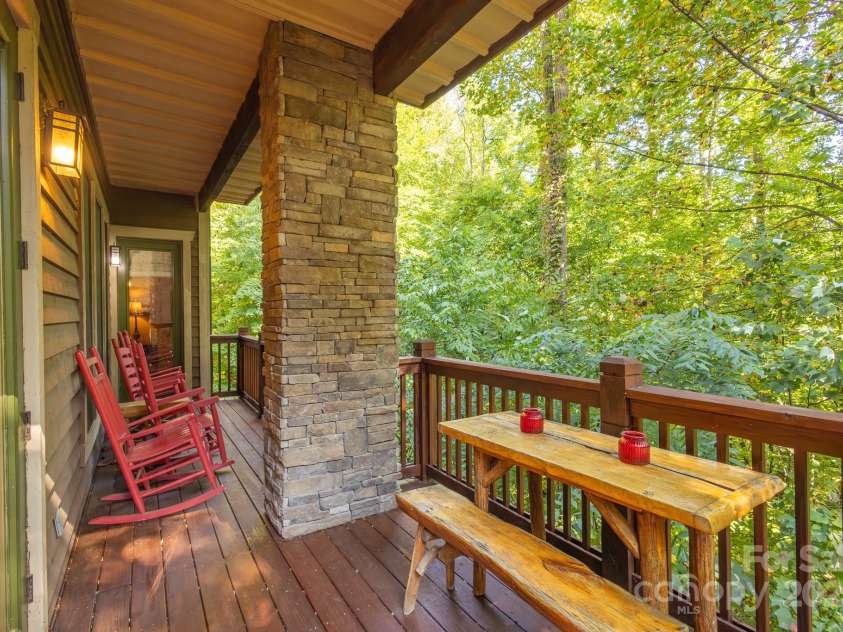 150-2 Saddle Notch Lane, Tuckasegee, NC 28783.  MLS# CAR4181029, YatesRealty ID 15075. Large full length porch overlooks forest below