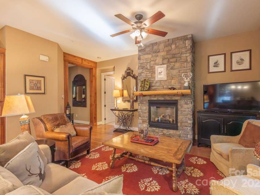 150-2 Saddle Notch Lane, Tuckasegee, NC 28783.  MLS# CAR4181029, YatesRealty ID 15075. Living room with Stone gas fireplace 