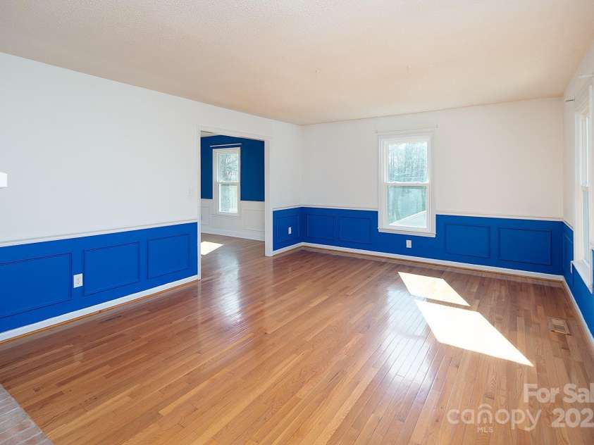 916 Rollingwood Drive, Mount Holly, NC 28120.  MLS# CAR4241352, YatesRealty ID 15080. Living Room/Office Space with Brick Fireplace Hardwood Floors