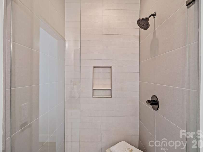 9 Gudger Road, Asheville, NC 28806.  MLS# CAR4406363, YatesRealty ID 15085. Custom Tiled Shower in the Primary Suite