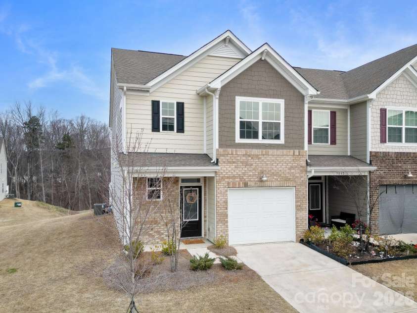 5044 Moss Pine Way, Tega Cay, SC 29708.  MLS# CAR4371971, YatesRealty ID 15096. Classic brick and hardboard siding townhome in sought-after Windhaven, Tega Cay. Charming curb appeal with a welcoming front door, manicured entry, and attached garage — all under a Carolina blue sky.