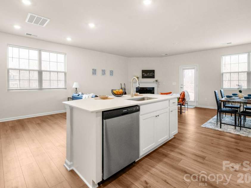 5044 Moss Pine Way, Tega Cay, SC 29708.  MLS# CAR4371971, YatesRealty ID 15096. See the full picture. This open-concept main floor flows seamlessly from the kitchen island through the dining space and into the living room — perfect for entertaining or everyday family life.