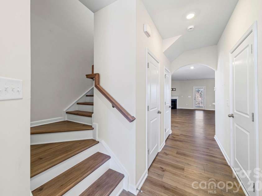 5044 Moss Pine Way, Tega Cay, SC 29708.  MLS# CAR4371971, YatesRealty ID 15096. Step inside to rich hard floor stairs, a soaring entryway, and an elegant arched doorway that draws you naturally into the open main floor. First impressions don't get much better than this.