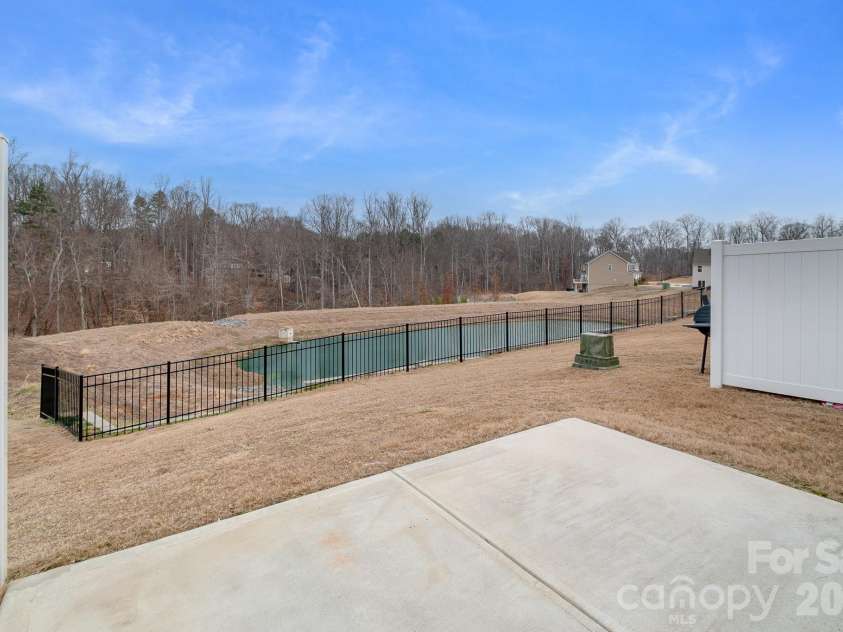 5044 Moss Pine Way, Tega Cay, SC 29708.  MLS# CAR4371971, YatesRealty ID 15096. Your private outdoor escape with a peaceful pond view beyond the fence — a rare find in a townhome community. No rear neighbors, just open sky and the sounds of nature.