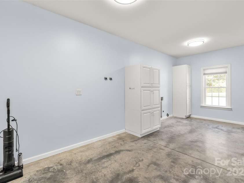 3009 Brooks Mill Lane, Wingate, NC 28174.  MLS# CAR4293288, YatesRealty ID 15104. Huge laundry just off the kitchen has ample room for folding tables, storage of supplies and makes a great drop zone in a convenient location.