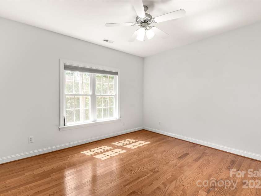 3009 Brooks Mill Lane, Wingate, NC 28174.  MLS# CAR4293288, YatesRealty ID 15104. Just off the living area is one of two guest rooms. Hardwood flooring and double-door closet