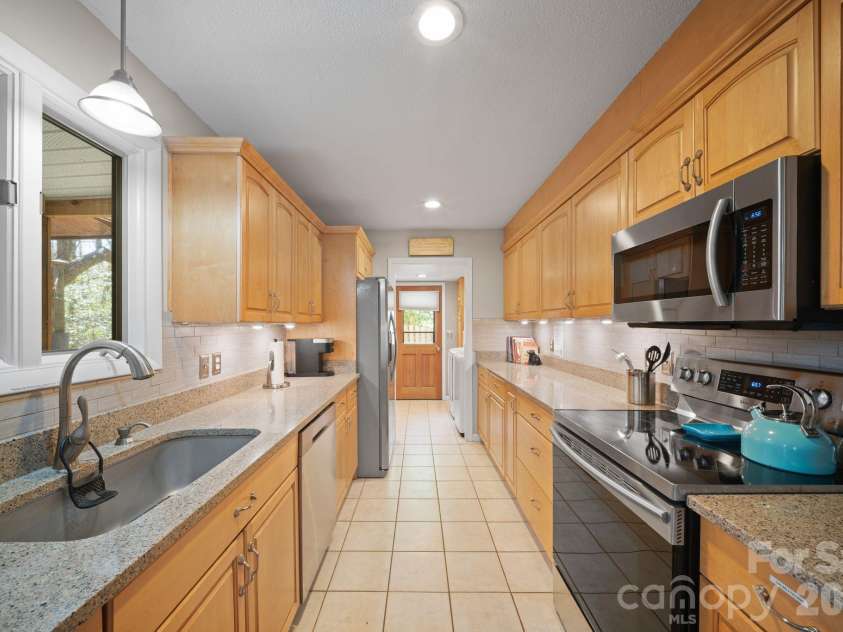 363 Sequoyah Lane, Brevard, NC 28712.  MLS# CAR4370995, YatesRealty ID 15106. Kitchen with laundry room attached