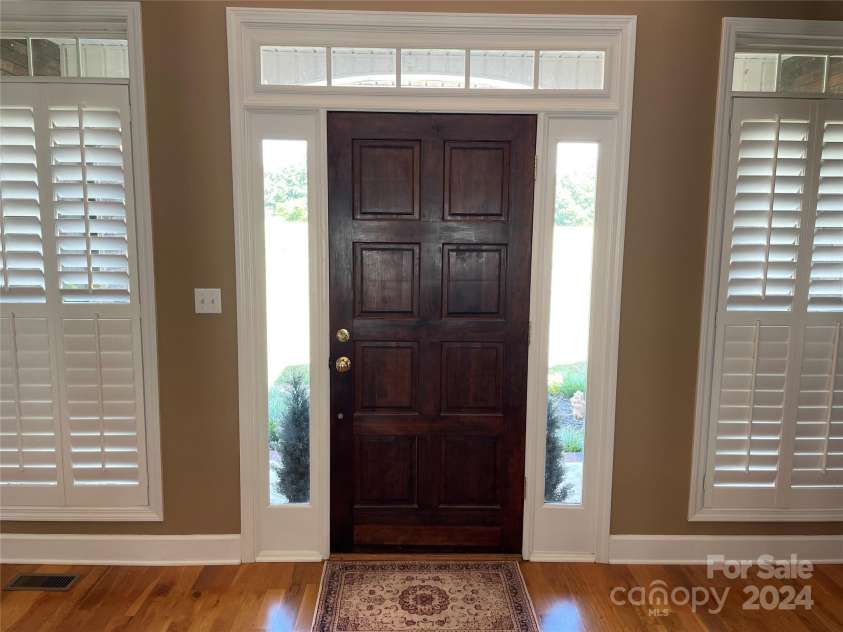 115 Anson Drive, China Grove, NC 28023.  MLS# CAR4146594, YatesRealty ID 1512. Beautiful Front door entrance, outlined with plantation shutters - a theme throughout the house