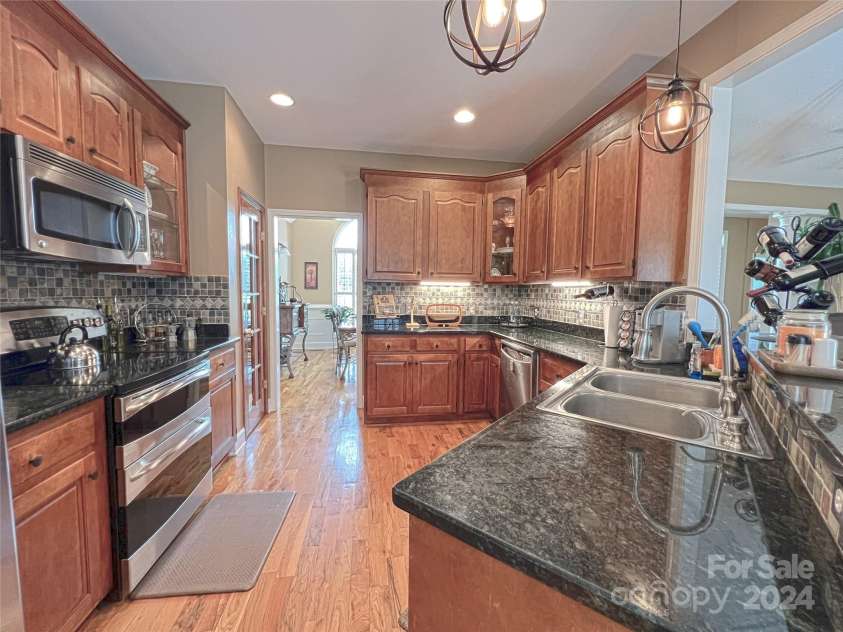 115 Anson Drive, China Grove, NC 28023.  MLS# CAR4146594, YatesRealty ID 1512. Kitchen with abundance of storage, pantry, stainless appliances and eat at bar for wonderful conversations