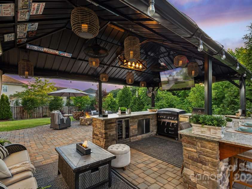 4430 Bravery Place, Concord, NC 28027.  MLS# CAR4260859, YatesRealty ID 15120. Covered permanent gazebo, featuring refrigerator, Blackstone,  additional grill, granite topped stone bar.