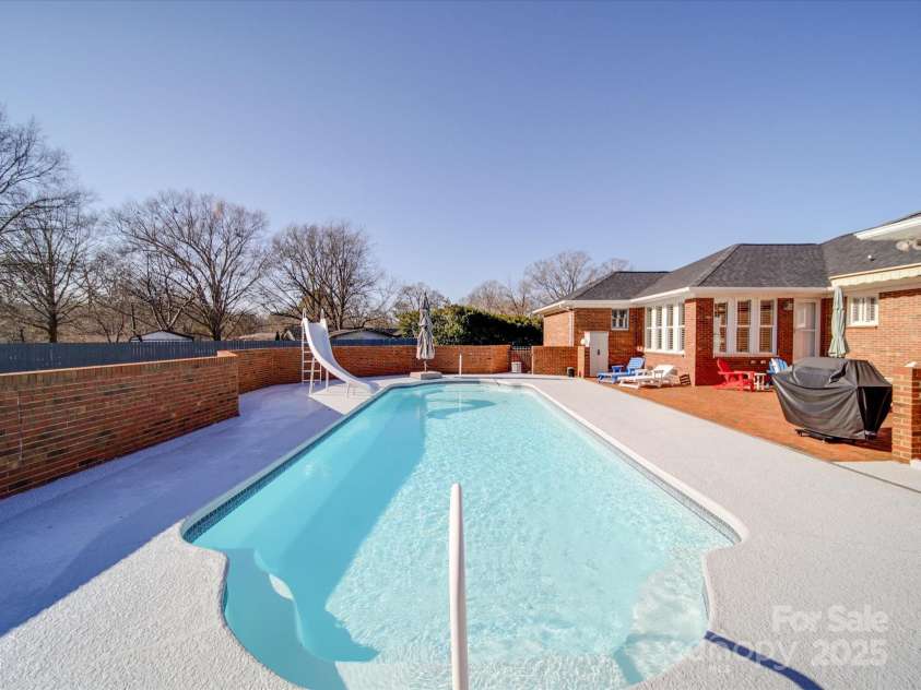 7169 Pleasant Grove Road, Charlotte, NC 28216.  MLS# CAR4214208, YatesRealty ID 15135. Cool deck coating (white) around the pool