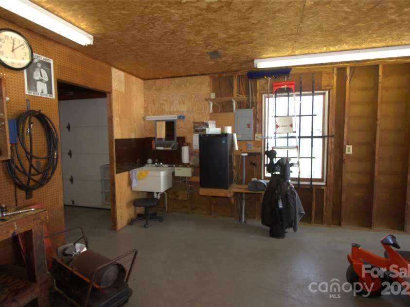 7169 Pleasant Grove Road, Charlotte, NC 28216.  MLS# CAR4214208, YatesRealty ID 15135. Detached garage workshop w/ sink