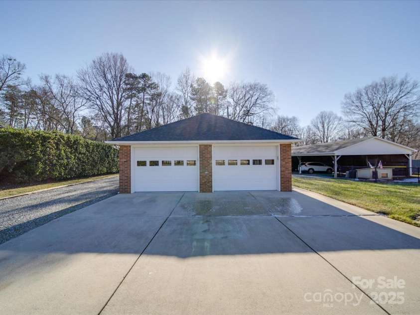 7169 Pleasant Grove Road, Charlotte, NC 28216.  MLS# CAR4214208, YatesRealty ID 15135. Detached, heated, 2 car garage with workshop. side entry door for lawnmower.