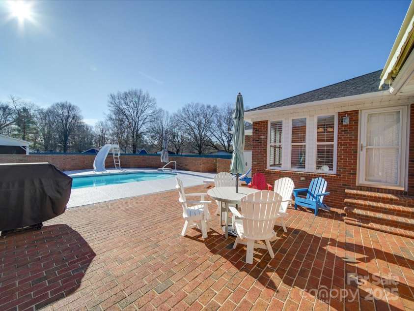 7169 Pleasant Grove Road, Charlotte, NC 28216.  MLS# CAR4214208, YatesRealty ID 15135. Large brick paver patio area around the pool