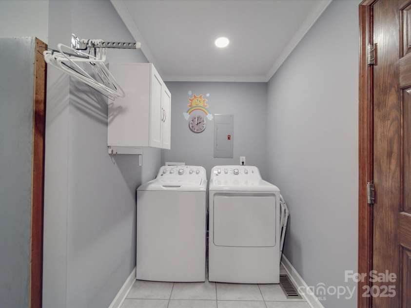 7169 Pleasant Grove Road, Charlotte, NC 28216.  MLS# CAR4214208, YatesRealty ID 15135. Laundry with storage area and sink