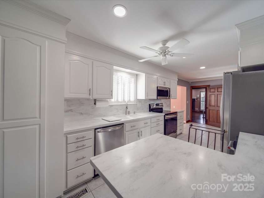 7169 Pleasant Grove Road, Charlotte, NC 28216.  MLS# CAR4214208, YatesRealty ID 15135. Modern white kitchen