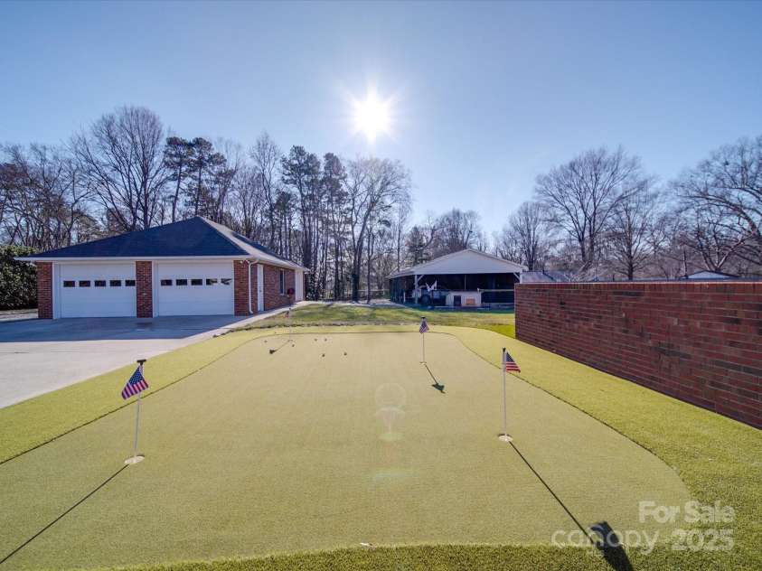 7169 Pleasant Grove Road, Charlotte, NC 28216.  MLS# CAR4214208, YatesRealty ID 15135. Professionally installed putting green