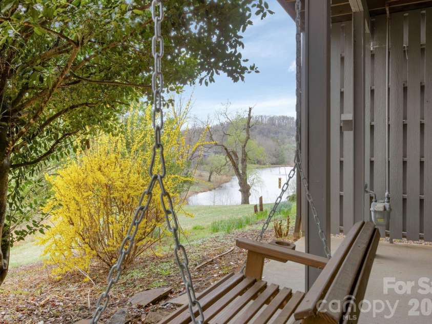 403 Crowfields Drive, Asheville, NC 28803.  MLS# CAR4348824, YatesRealty ID 15152. Back patio with swing