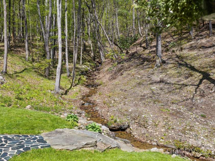 5712 Summit Road, Purlear, NC 28665.  MLS# CAR4141857, YatesRealty ID 1516. Spring Fed Creek Viewed From Back Porch