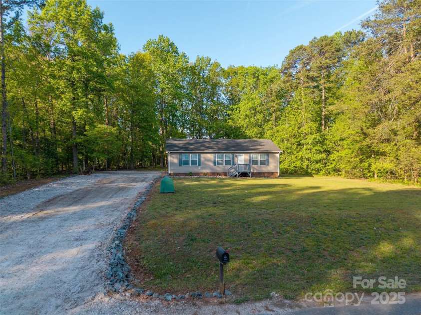 5039 Pine Springs Drive, Bessemer City, NC 28016.  MLS# CAR4249727, YatesRealty ID 15175. Large freshly poured gravel driveway offering plenty of parking and showing off all of the privacy