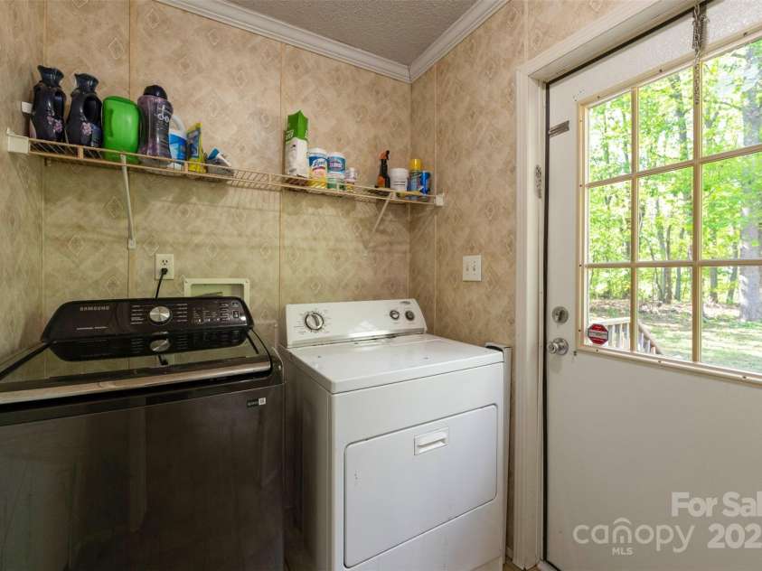 5039 Pine Springs Drive, Bessemer City, NC 28016.  MLS# CAR4249727, YatesRealty ID 15175. Laundry room located in the back of the house just off the kitchen with access to the back deck