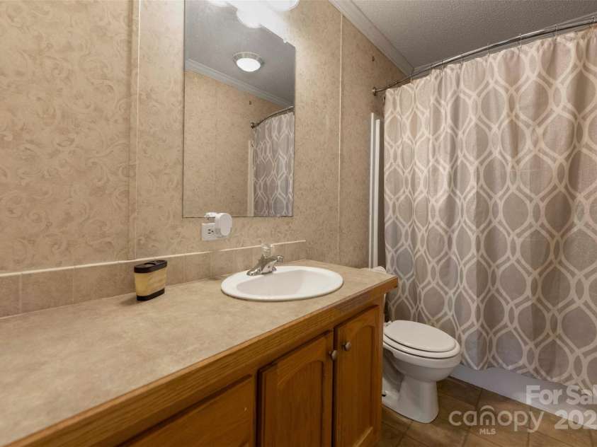 5039 Pine Springs Drive, Bessemer City, NC 28016.  MLS# CAR4249727, YatesRealty ID 15175. Secondary bath with tons of counter space and shower/tub combo