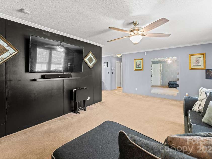 5039 Pine Springs Drive, Bessemer City, NC 28016.  MLS# CAR4249727, YatesRealty ID 15175. This view is from the corner of the living room looking toward the secondary bedrooms down the small hallway