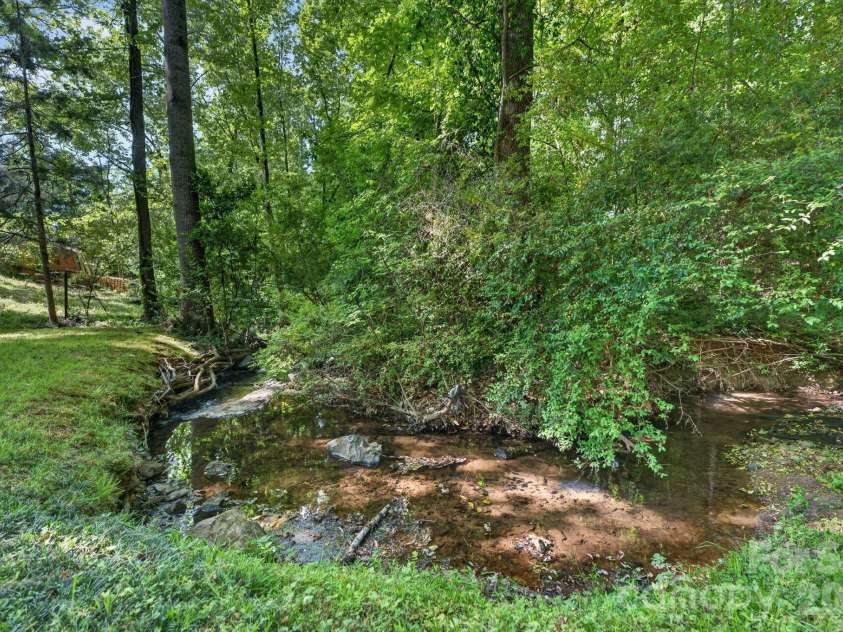 7401 Beaufort Circle, Charlotte, NC 28227.  MLS# CAR4372097, YatesRealty ID 15190. Small creek in backyard