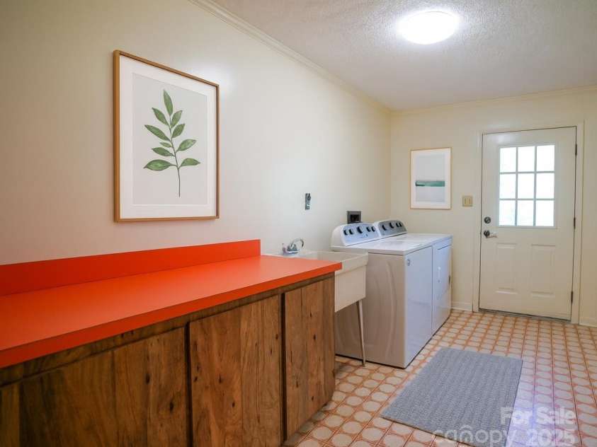 262 Rooster Cove, Brevard, NC 28712.  MLS# CAR4332799, YatesRealty ID 15209. Main level laundry room w/ deck access, utility sink, folding area, fold down ironing board, large closet, washer and dryer