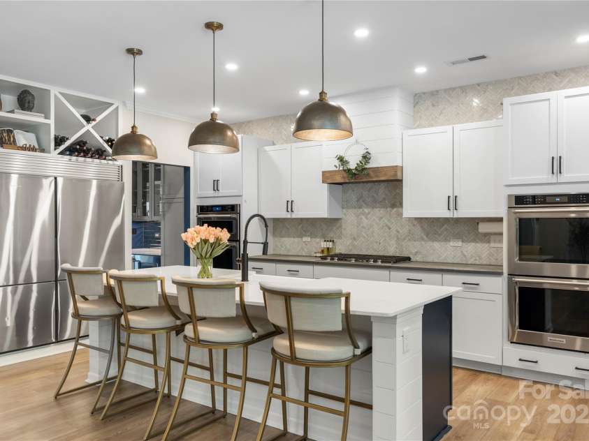 5050 Havencrest Drive, Fort Mill, SC 29715.  MLS# CAR4261068, YatesRealty ID 15224. Dual refrigerator, custom lighting and woodwork on the space above the refrigerators and vent hood.