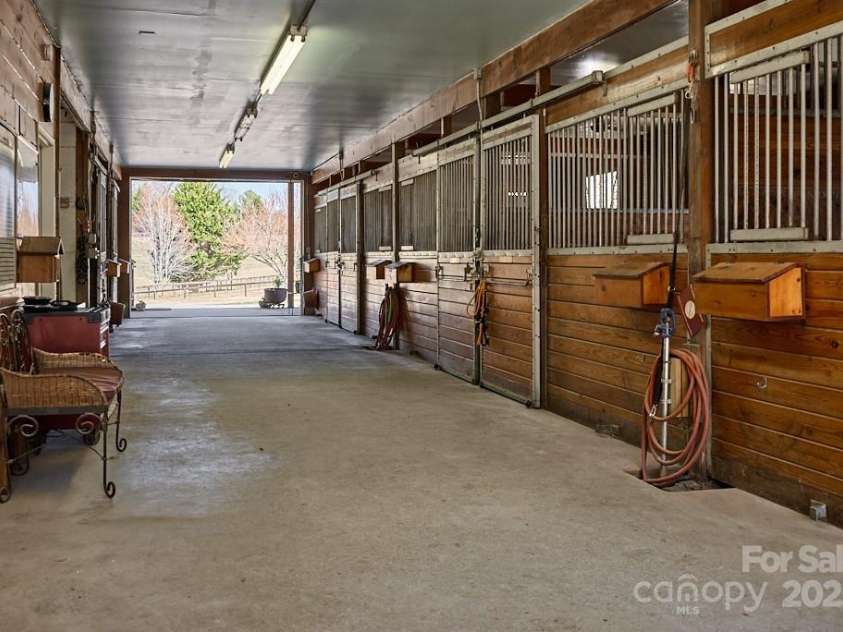 226 John Smith Road, Columbus, NC 28722.  MLS# CAR4235483, YatesRealty ID 15228. Center aisle barn with 8 stalls