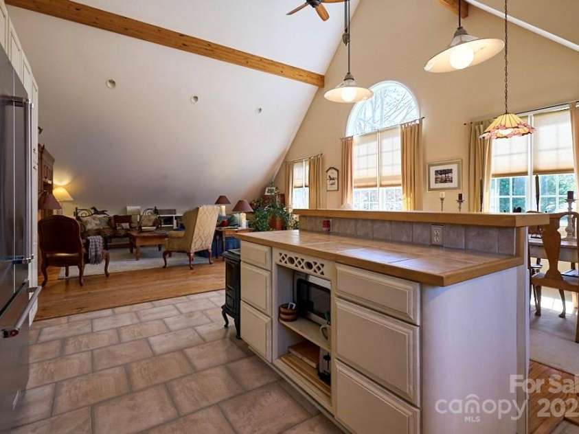 226 John Smith Road, Columbus, NC 28722.  MLS# CAR4235483, YatesRealty ID 15228. Spacious Great Room with Kitchen Island, Dining Area, and Living Room Area