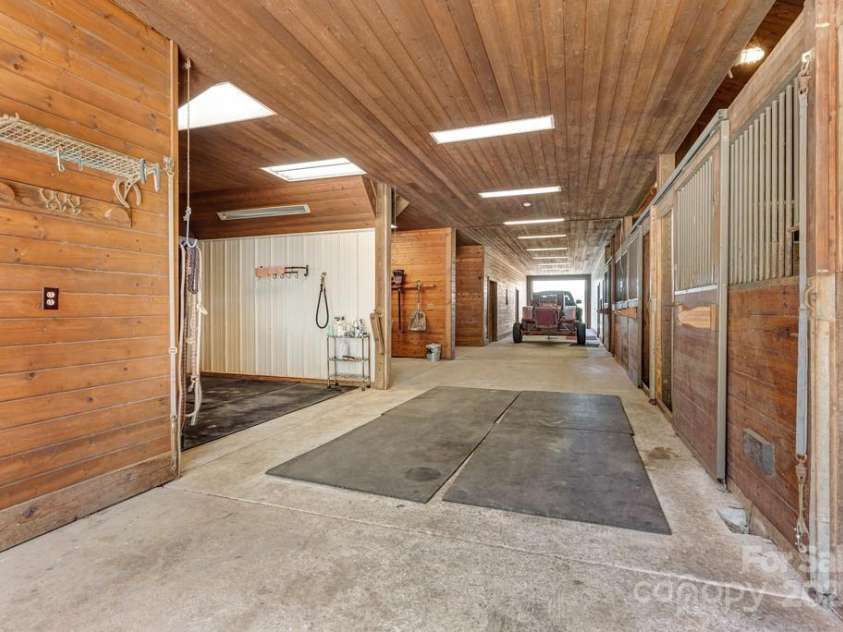 201 Hughes Creek, Columbus, NC 28722.  MLS# CAR4259120, YatesRealty ID 15229. Center aisle barn with 4 stalls