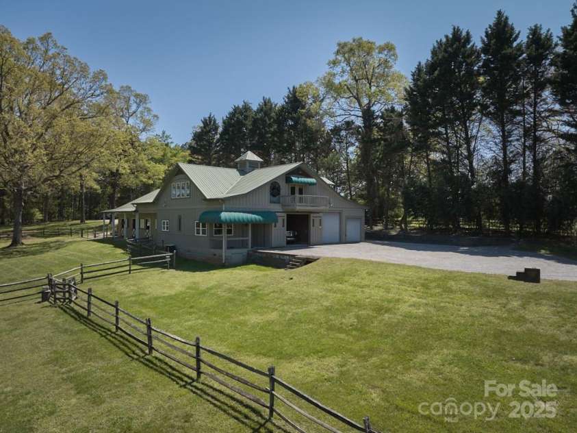 201 Hughes Creek, Columbus, NC 28722.  MLS# CAR4259120, YatesRealty ID 15229. Center aisle barn with paddocks & auto waterers