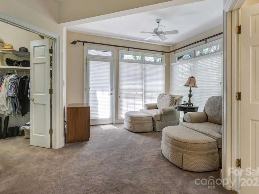 201 Hughes Creek, Columbus, NC 28722.  MLS# CAR4259120, YatesRealty ID 15229. Sitting area in Primary bedroom with doors that open to the deck