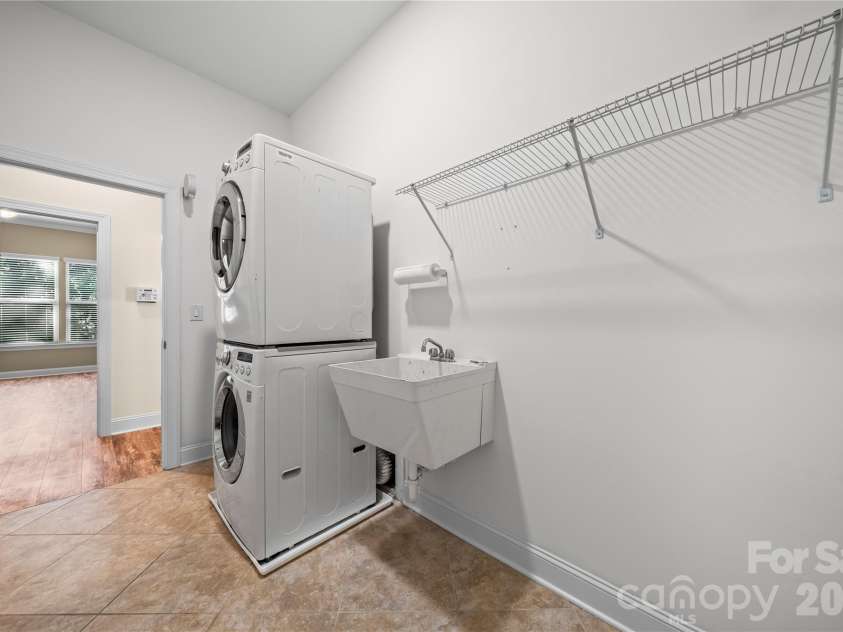 7017 Hyde Park Drive, Indian Trail, NC 28079.  MLS# CAR4369830, YatesRealty ID 15235. Large laundry room with stackable washer/dryer