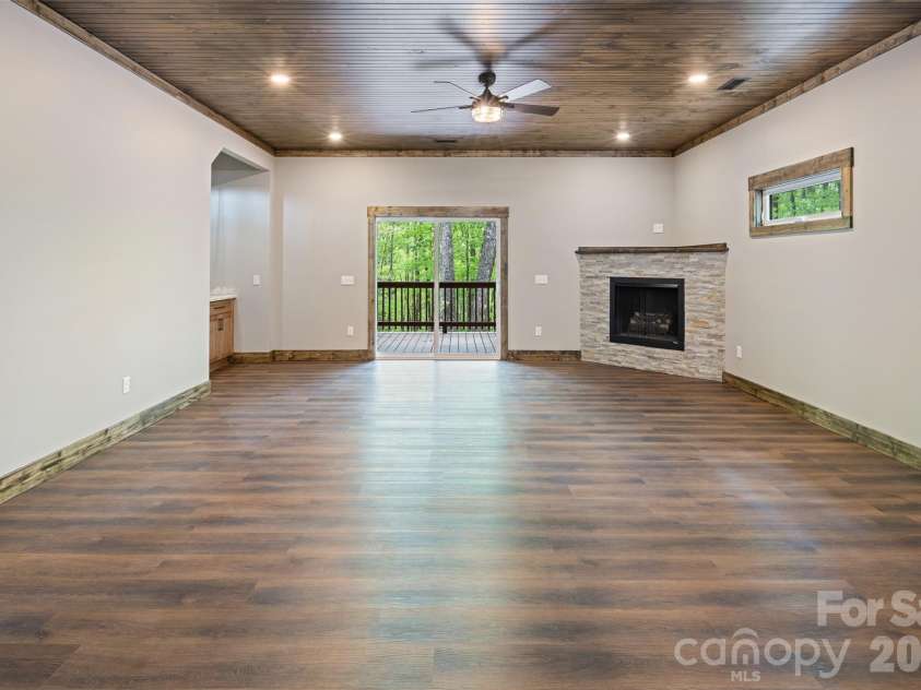 115 Pine Burr Drive, Purlear, NC 28665.  MLS# CAR4374403, YatesRealty ID 15245. Lower Level - Den with Gas Log Fireplace