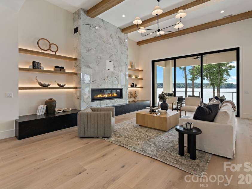 127 Tinker Place, Troutman, NC 28166.  MLS# CAR4394481, YatesRealty ID 15255. Linear fireplace and custom shelves with built-in lighting