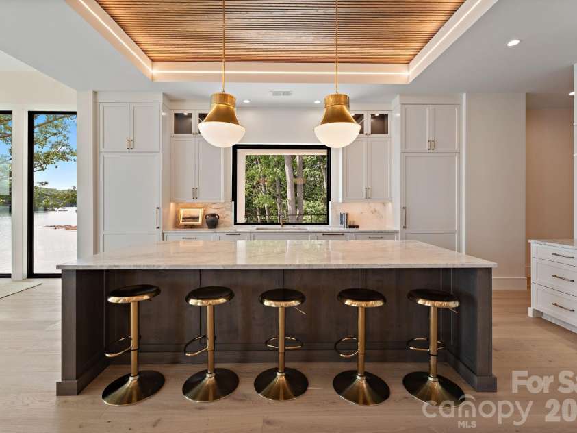 127 Tinker Place, Troutman, NC 28166.  MLS# CAR4394481, YatesRealty ID 15255. Marble countertops. Custom millwork. Designer lighting. Lake Norman views.