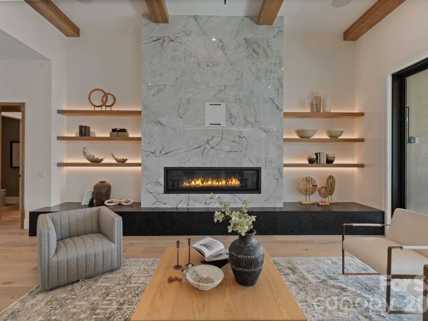 127 Tinker Place, Troutman, NC 28166.  MLS# CAR4394481, YatesRealty ID 15255. Sleek linear fireplace, floating shelves with custom LED lighting